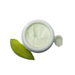 Cream jar with green cream and green leaf, white background