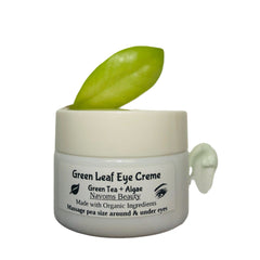 Eye cream jar with white container, green leaf, and Navoms Beauty label