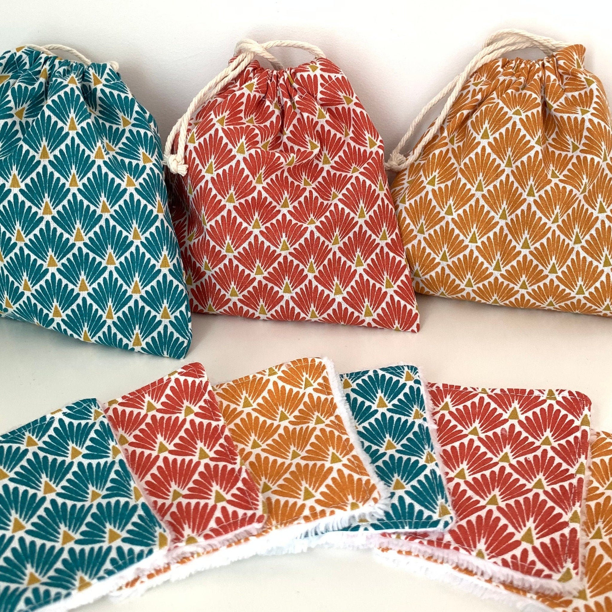 Stack of reusable bamboo makeup remover wipes with natural fiber texture on wooden surface