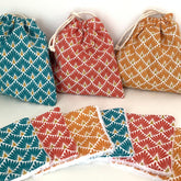 Stack of reusable bamboo makeup remover wipes with natural fiber texture on wooden surface