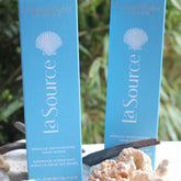 Hand scrub product with blue packaging, white seashell logo, and Crabtree & Evelyn brand text visible