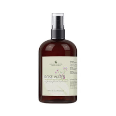 Rose water bottle, brown glass bottle with black spray top, white label with text