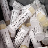 Lipstick topcoat tubes with white labels, clear tubes, and Bee's Knees brand name visible
