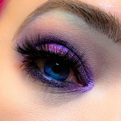 Side angle view of Voodoo Dolly multichrome eyeshadow pot showcasing shifting iridescent pigments