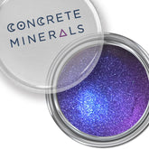 Voodoo Dolly multichrome eyeshadow pot showcasing shifting iridescent hues in purple, green, and gold tones