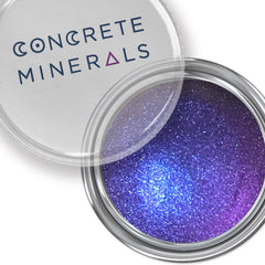 Voodoo Dolly multichrome eyeshadow pot showcasing shifting iridescent hues in purple, green, and gold tones