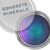 Eyeshadow with multichrome purple, blue, and green shimmer in a metal tin, Concrete Minerals brand