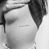 Three delicate temporary tattoos with 'You Are Enough' script in gold on clear backing, skincare-inspired design