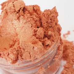 Eyeshadow shimmer peach powder in clear jar, glittery texture, for eye makeup application