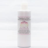 Amber glass bottle of vitamin A D E serum with gold dropper and minimalist black label