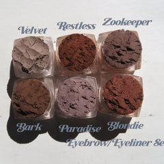 Six matte brown loose mineral eyeshadows in round jars with black lids, vegan and cruelty-free.