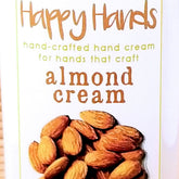 Minimalist white tube of almond-scented shea butter hand cream with gold accents and matte finish