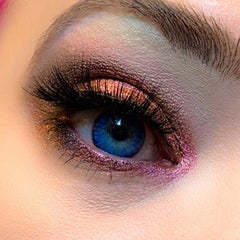 Eye makeup with blue eye, pink and brown eyeshadow, and black eyelashes