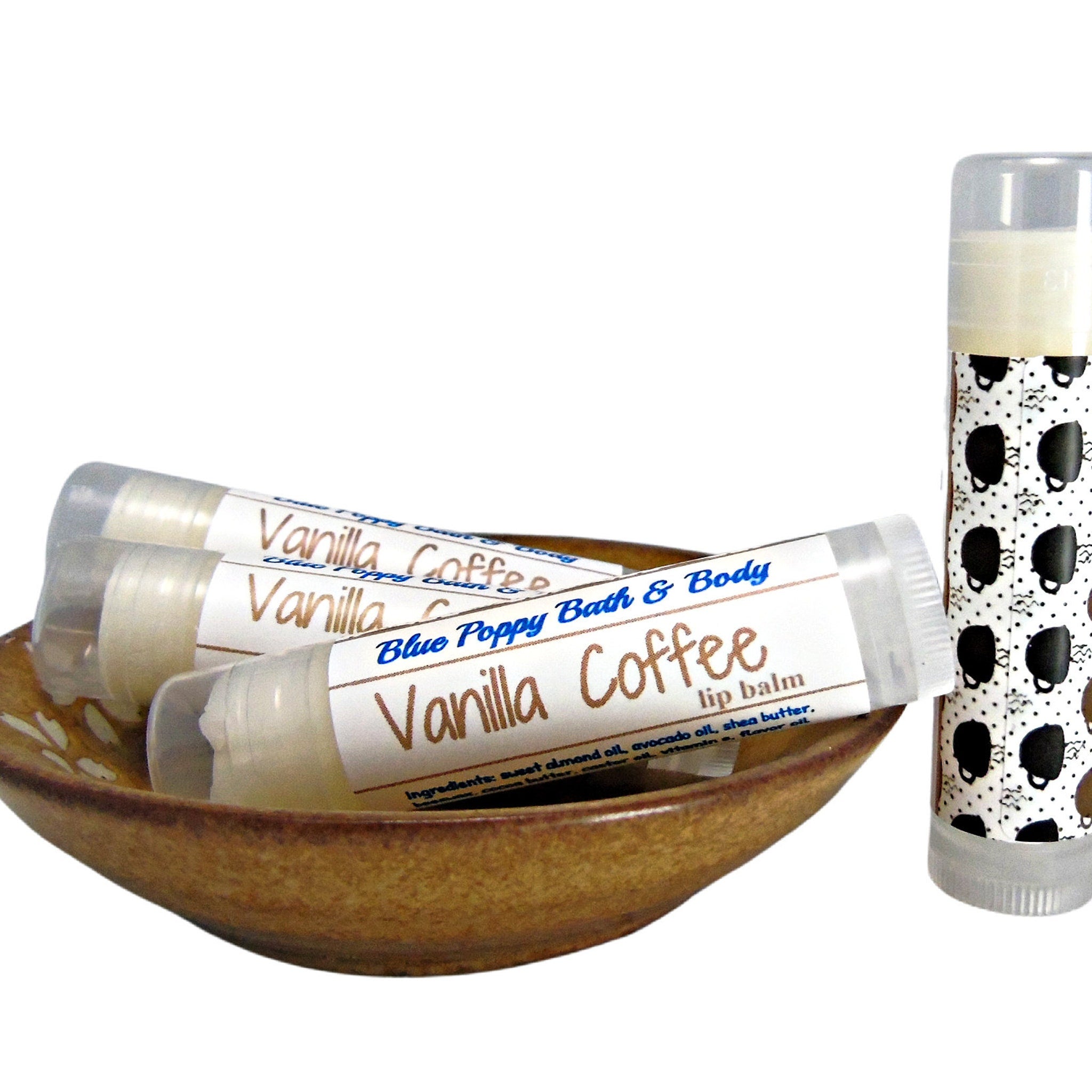Lip balm tubes with white labels, brown text, and coffee cup pattern, Blue Poppy Bath & Body brand visible