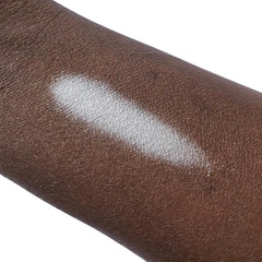 White swatch on dark brown skin, showing texture and color contrast