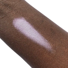 Swatched eyeshadow, light purple color, applied on dark skin, highlighting effect