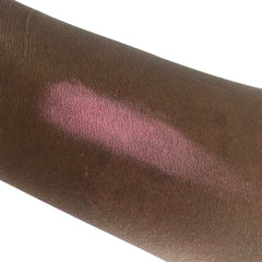 Blush swatch on arm, pink powder, skin tone test, visible texture