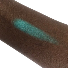 Hand applying shimmering bronze mineral eyeshadow with a fluffy brush for a blended look