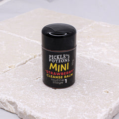 Mini cleanse balm in black and yellow label on stone surface, Pickle's Potions brand
