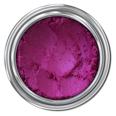 Magenta powder in a silver metal container, textured surface, top view