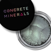 Vegan eyeshadow, metallic green powder, black lid with Concrete Minerals text, silver container