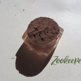 Dark matte brown mineral eye shadow in loose powder form with vegan, cruelty-free label visible