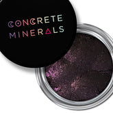 Mineral eyeshadow in dark purple with silver shimmer, in a round metal container, Concrete Minerals brand