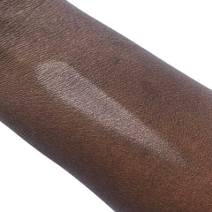 Skin swatch showing brown skin with a light silver streak applied to the arm
