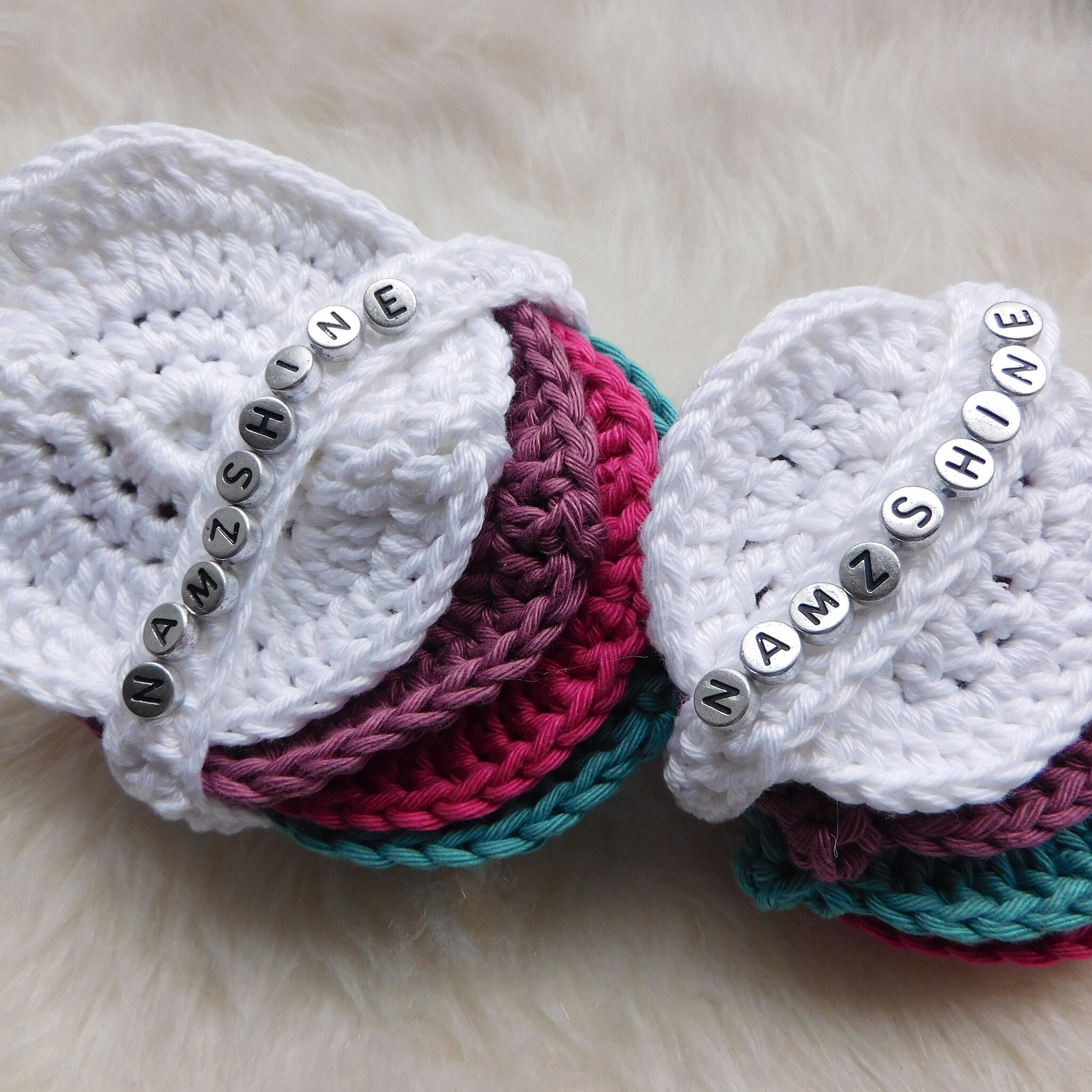 Makeup removal pads, white crocheted cotton, multi-color pads stacked, "NAMZSHINE" text