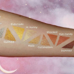 Eyeshadow swatches with various metallic colors on skin, including gold and bronze shades, for makeup application.