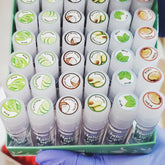 Lip gloss bundle, white tubes with colorful labels, Beauty Treats Natural Lip Oil visible