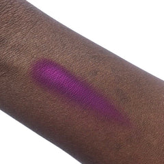 Purple swatch on dark skin, showing color and texture of skin