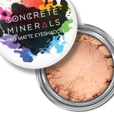 Eyeshadow powder with light brown color in a silver metal container, Concrete Minerals brand visible