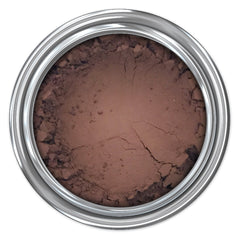 Brown powder makeup in a silver metal container, showing texture and cracks