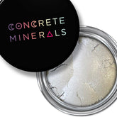 Mineral eyeshadow with silver-white powder, black lid with Concrete Minerals text, metallic container