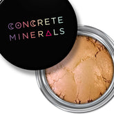 Eye makeup eyeshadow in tan and peach tones, with Concrete Minerals logo on black lid, in a silver container