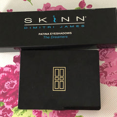 SKINN eyeshadow palette, black rectangular case, gold door design, brand name visible
