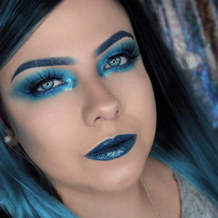 Side view of West Coast mineral eyeshadow pot showing matte taupe powder and sleek black compact