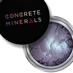 Eyeshadow pot with purple and silver shimmer, Concrete Minerals brand on black lid