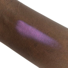 Purple eyeshadow swatch on dark skin, showing color and texture of product application