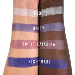 Square compact of Sweet Catrina Mineral Eyeshadow with floral design on matte black packaging, open to reveal pressed powder.