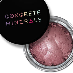 Close-up of Sweet Catrina Mineral Eyeshadow in a round compact with vibrant matte finish and embossed logo