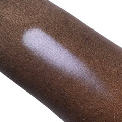 Makeup swatch on dark skin, light purple shimmer, skin texture visible, angled view