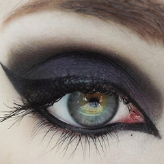 Eye makeup with black and purple eyeshadow, winged eyeliner, and long black lashes