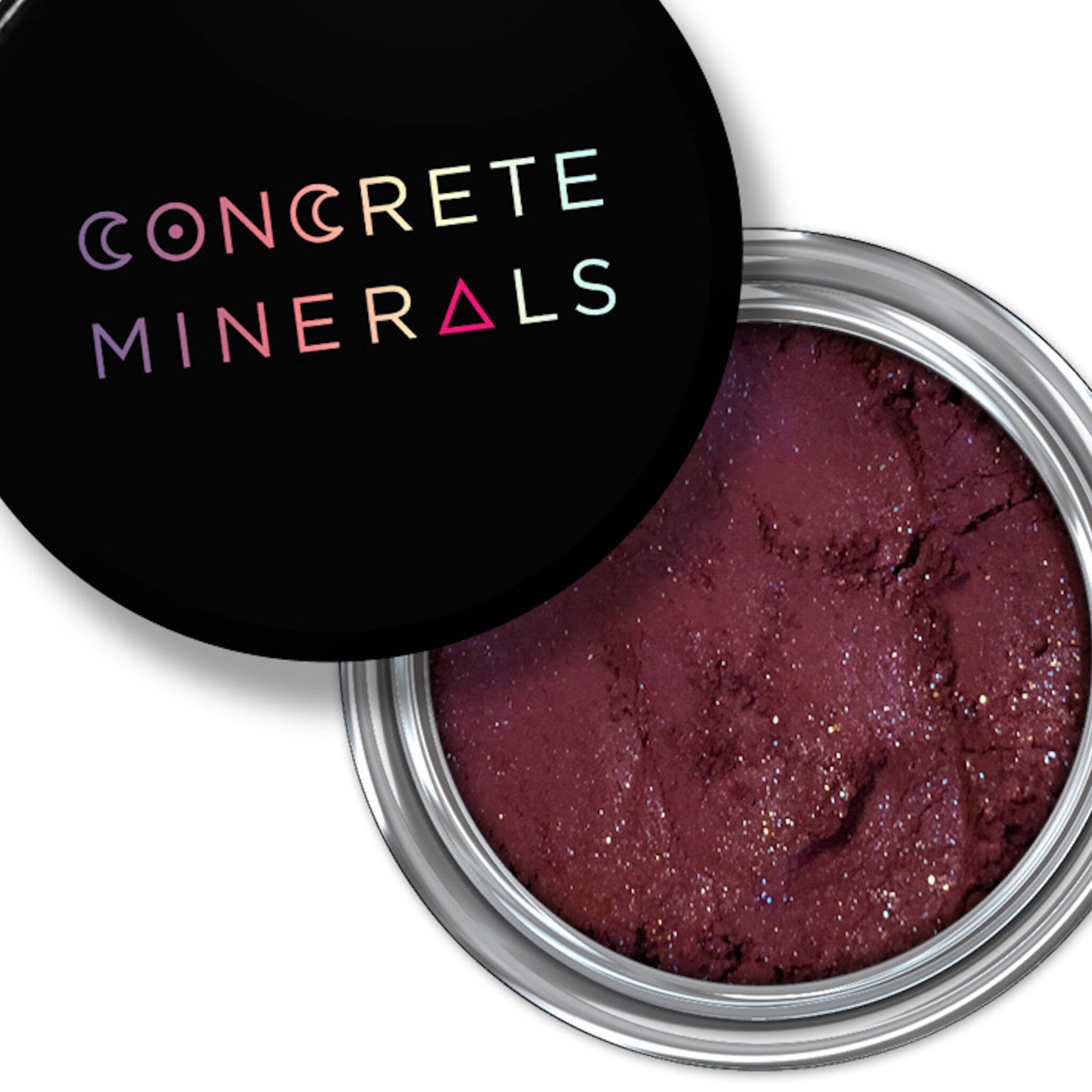 Close-up of To Boldly Go Mineral Eyeshadow in a compact with shimmering cosmic-inspired hues and sleek black packaging