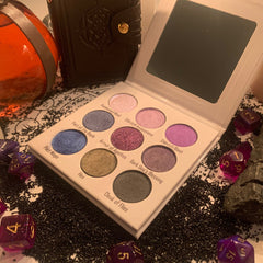 Close-up of D&D Warlock Eyeshadow Palette showing shimmering purple and black shades with intricate rune designs