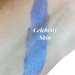 Celebrity Skin makeup swatch, blue metallic shimmer, applied on skin, brand name visible