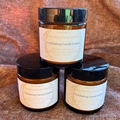 Exfoliating Facial Grains in amber glass jars with black lids, "Amber's Handcrafts & Herbs" label