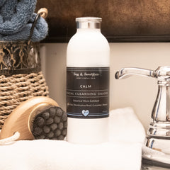 Facial cleansing grains white bottle with black label and silver cap, Sage & Sweetgrass product