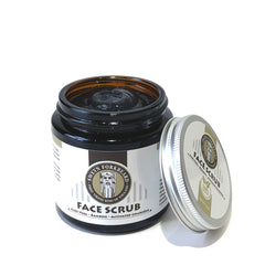 Face scrub jar with brown glass, black cream, and silver lid, Sweyn Forkbeard brand visible